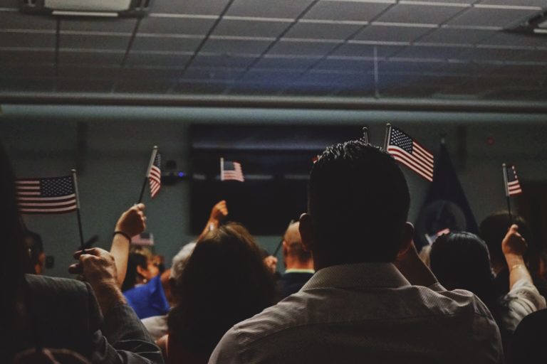 Image of people inside holding up small American flags