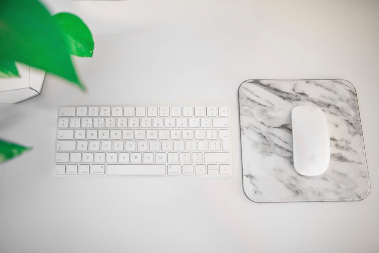 Image of a mouse and keyboard on clean white desk