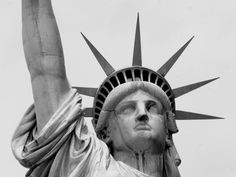 Closeup image of the stutue of liberty's face in black and white