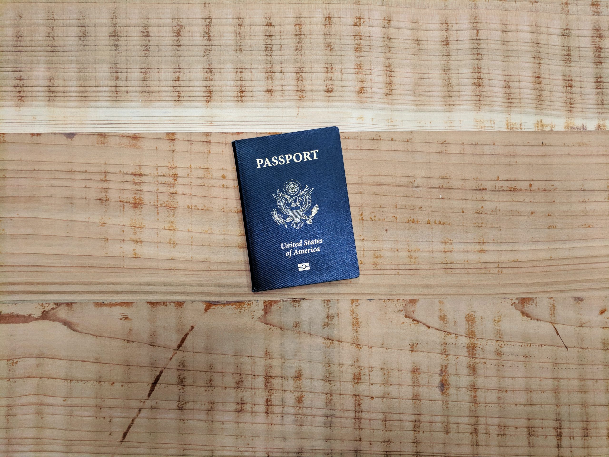 Image of a U.S. Passport against a wood background