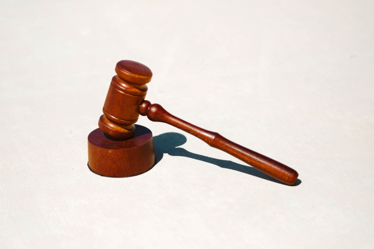 Image of a brown judge's gavel on a white background