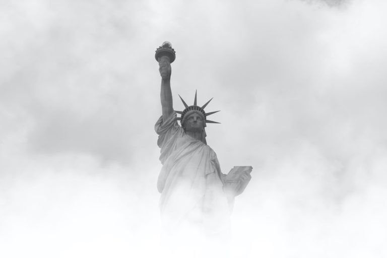 Image of the statue of liberty emerging from fog.