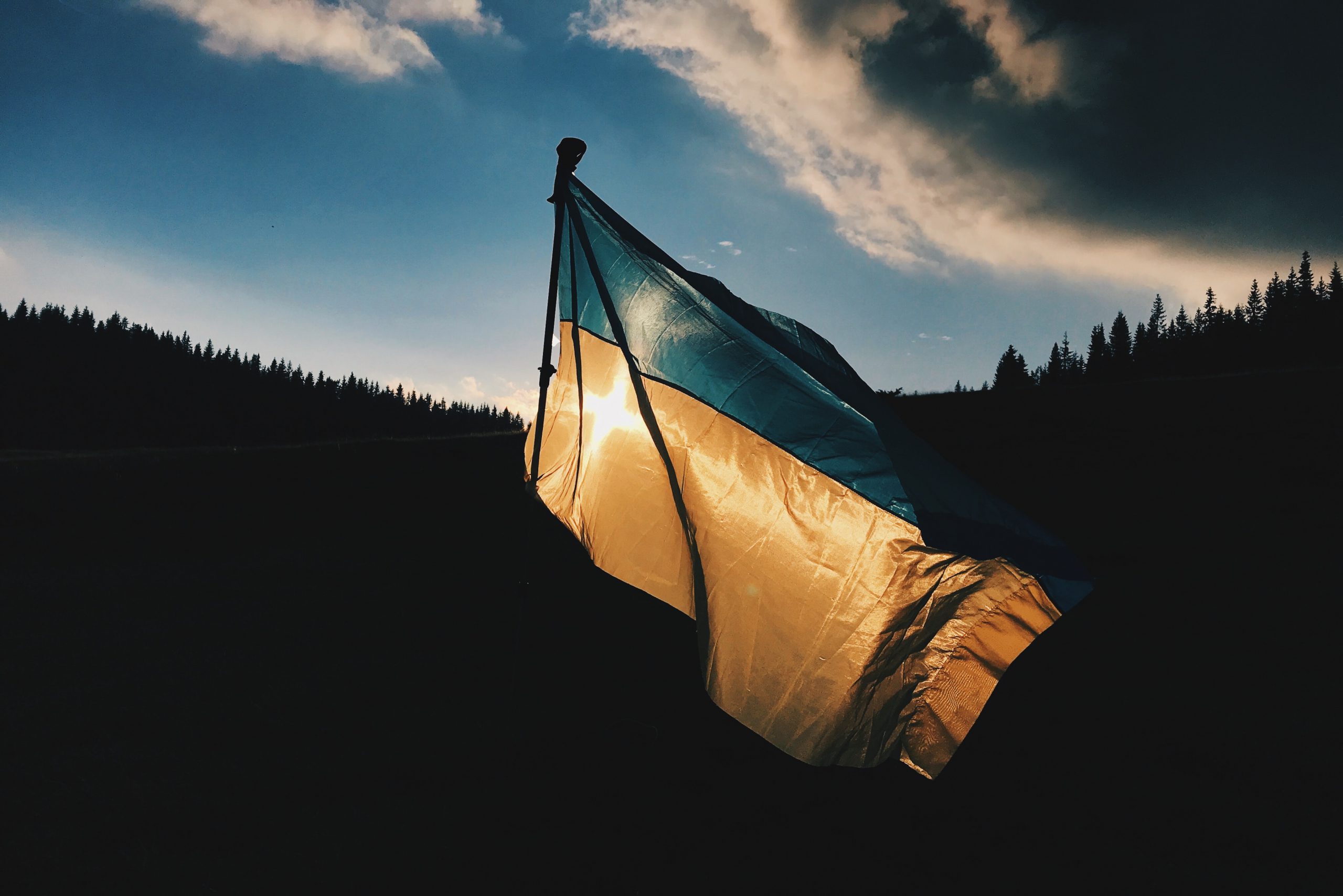 Image of the Ukrainian flag flying in the sunset