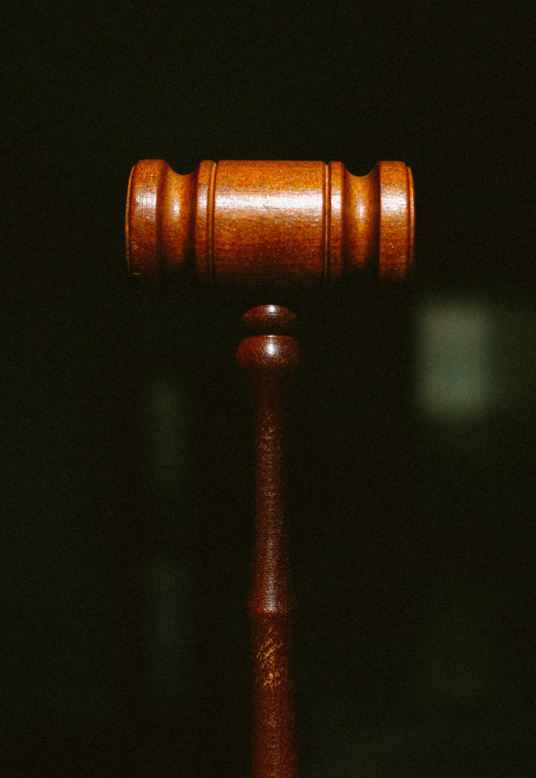 Image of a judge's gavel on a black background