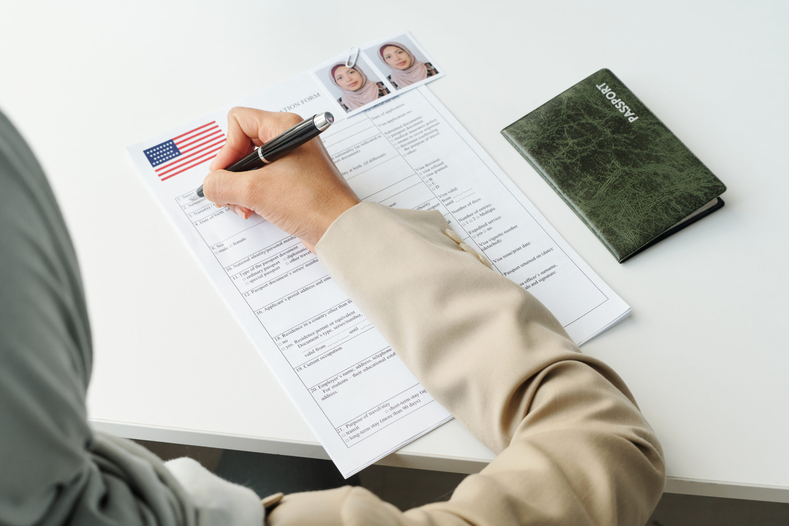 USCIS fees set to increase on April 01, 2024. Image of a woman filling out application at USCIS.