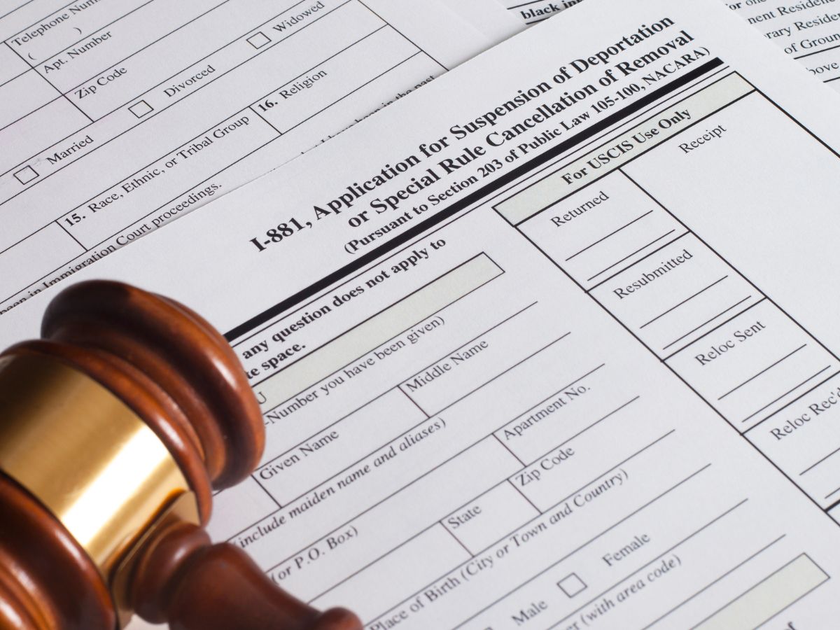 Image of a gavel and immigration forms. Reliable deportation defense in Overland Park.